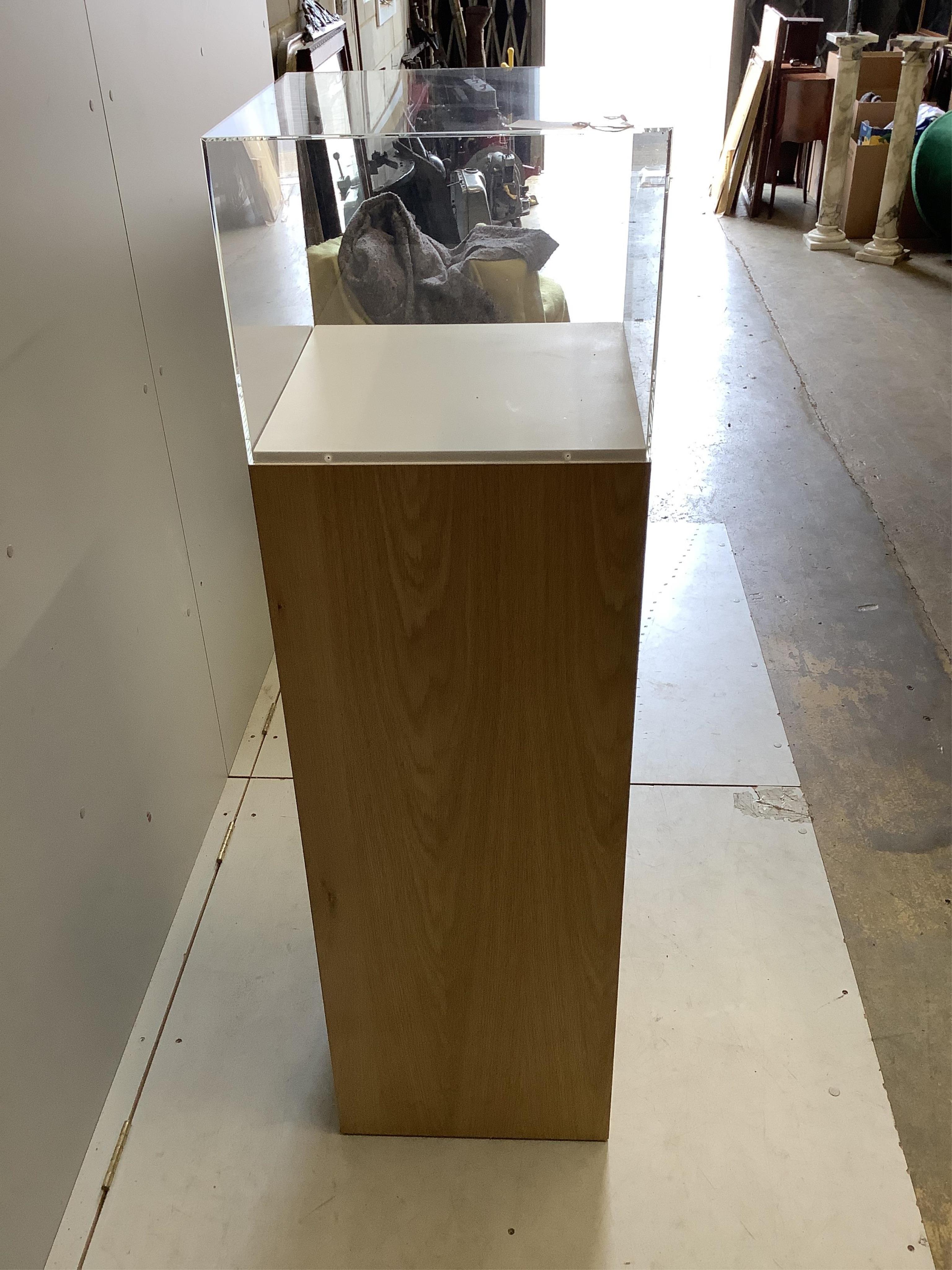 Three oak and perspex display plinths, largest height 145cm. Condition - fair